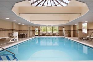 a large swimming pool with a skylight at Hampton Inn Long Island-Brookhaven in Farmingville