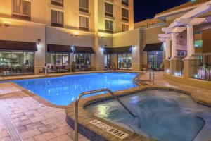 a swimming pool at a hotel at night at Hilton Garden Inn Jacksonville Downtown Southbank in Jacksonville