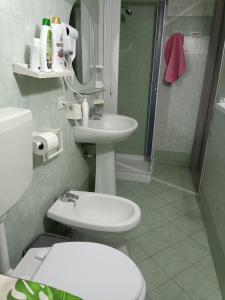 a bathroom with a toilet and a sink and a shower at Holiday home La Rinascita in Bagheria