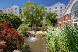 a garden with a pond in front of a building at Homewood Suites Lansdale in Lansdale
