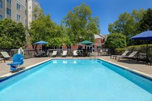 a large swimming pool with chairs and umbrellas at Homewood Suites Lansdale in Lansdale