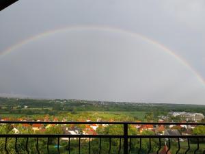 a view of a city from a balcony with a rainbow at Manor Villa in Hévíz