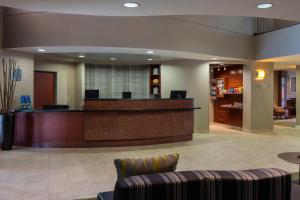 a lobby with a reception desk and a waiting room at Courtyard by Marriott Daytona Beach Speedway/Airport in Daytona Beach