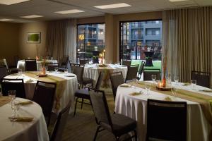 a restaurant with tables and chairs with white tablecloths at Courtyard by Marriott Perimeter Center in Atlanta