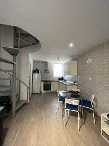 a kitchen and dining room with a table and chairs at El Cortijo Bungallows in Playa de las Americas