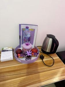 a table with a bowl of fruit and a bottle of water at The Purple Place in Abu Dhabi