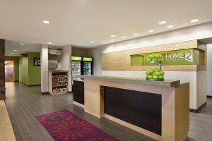 a lobby of a home store with a counter with apples on it at Home2 Suites by Hilton Salt Lake City / South Jordan in South Jordan