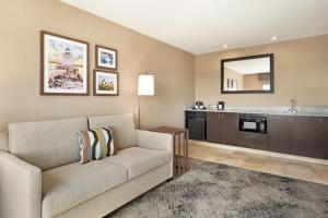 a living room with a couch and a sink at Hampton Inn Portland Downtown Waterfront in Portland