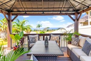 a patio with a table and couch on a deck at Breathtaking Ocean Views Brand New Home M934 in Waianae