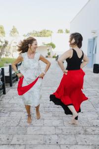 two women are walking down a brick street at Masseria Montelauro in Otranto