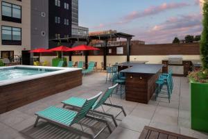 a patio with tables and chairs and a swimming pool at Home2 Suites By Hilton Nashville Downtown Convention Center in Nashville