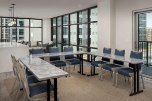 a dining room with a long table and chairs at Home2 Suites By Hilton Nashville Downtown Convention Center in Nashville