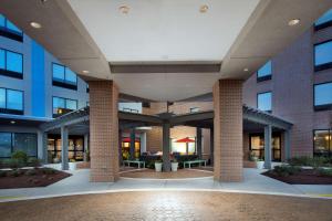 a large building with a courtyard with tables and chairs at Tru By Hilton Murfreesboro, Tn in Murfreesboro