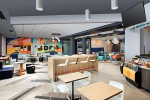 a restaurant with tables and chairs in a cafeteria at Tru By Hilton Murfreesboro, Tn in Murfreesboro