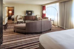 a hotel room with a bed and a living room at DoubleTree by Hilton Hotel Largo Washington DC in Largo