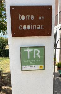 a sign for a centre of colombia on a building at TORRE de CODINAC in Sant Pere de Torelló