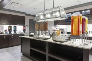 a large kitchen with a counter with glasses on it at Homewood Suites By Hilton Largo Washington Dc in Largo