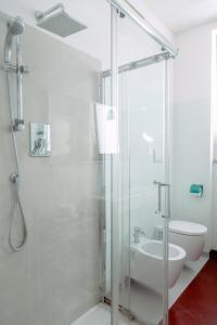 a bathroom with a glass shower and a toilet at Downtown Apartment in Pescara