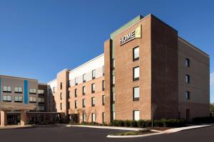 a large brick building with a baze sign on it at Home2 Suites By Hilton Murfreesboro in Murfreesboro