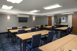 a conference room with tables and chairs and a screen at Courtyard Boise Downtown in Boise