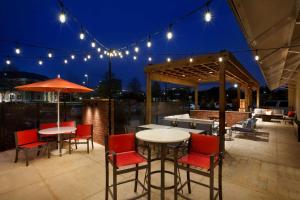 a patio with tables and chairs and lights at Embassy Suites by Hilton Jackson North Ridgeland in Ridgeland