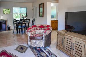 a living room with a chair and a flat screen tv at Cowboys & Angels - Classic Sedona style w/great location in Sedona