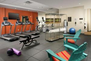 a gym with several exercise equipment in a room at Home2 Suites by Hilton Louisville East Hurstbourne in Louisville