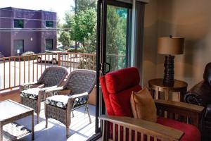 a living room with a balcony with chairs and a window at Cowboys & Angels - Classic Sedona style w/great location in Sedona