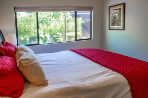 a bedroom with a bed with a red blanket on it at Cowboys & Angels - Classic Sedona style w/great location in Sedona