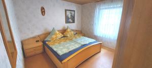 a small bedroom with a bed and a window at Apartment Popp Langen in Langen