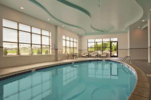 a pool in a hotel room with a large swimming pool at Embassy Suites by Hilton Knoxville West in Knoxville