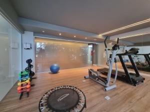 a gym with exercise equipment in a room at Marambaia Hotel e Convenções in Balneário Camboriú