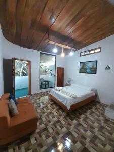 a large bedroom with two beds and a couch at Sky Blue Hospedaje in Puerto Villamil