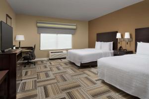 a hotel room with two beds and a desk and a window at Hampton Inn Knoxville-East in Knoxville