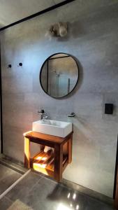 a bathroom with a sink and a mirror on a wall at Cabañas Abedul in Lago Meliquina