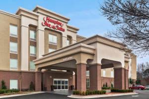 a front view of a holiday inn express building at Hampton Inn & Suites Atlanta Airport West Camp Creek Pkwy in Atlanta