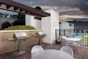 a patio with a grill and a table and chairs at Home2 Suites by Hilton Charleston Airport Convention Center, SC in Charleston