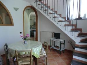 a dining room with a table and a staircase at Agriturismo Mare e Monti in Tramonti
