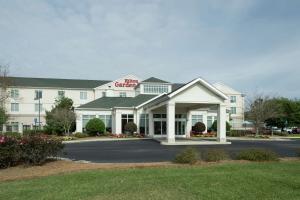 a hotel with a sign on the front of it at Hilton Garden Inn Dothan in Dothan