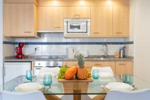 a kitchen with a glass table with fruit on it at Lanzahost Casa Juan in Costa Teguise