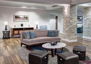 a living room with a couch and a table at Homewood Suites by Hilton Huntsville-Village of Providence in Huntsville