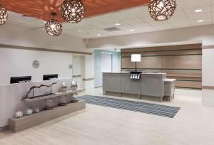 an empty lobby with a waiting room with a pharmacy at Hampton Inn & Suites by Hilton Carolina Beach Oceanfront in Carolina Beach