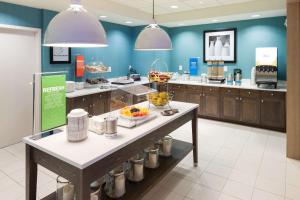 a kitchen with a counter with bowls of food on it at Hampton Inn & Suites by Hilton Carolina Beach Oceanfront in Carolina Beach