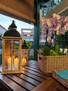 two lanterns on a table with flowers in a basket at Nikiti, four seasons house in Nikiti