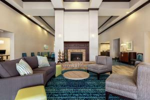 a lobby with couches chairs and a fireplace at Homewood Suites by Hilton Macon-North in Macon