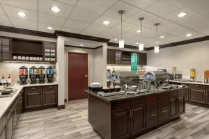 a large kitchen with wooden cabinets and a counter at Homewood Suites by Hilton Macon-North in Macon