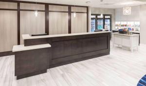 a lobby of a store with a reception desk at Homewood Suites by Hilton Cape Canaveral-Cocoa Beach in Cape Canaveral