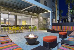 a patio with a fire pit and tables and chairs at Home2 Suites By Hilton Panama City Beach, Fl in Panama City Beach