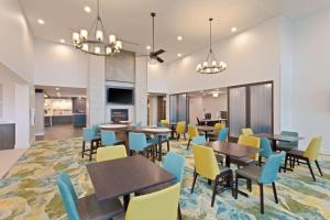 a dining room with tables and chairs at Homewood Suites by Hilton St Augustine San Sebastian in St. Augustine