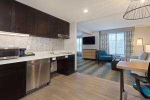 a kitchen and living room with a dining room at Homewood Suites by Hilton St Augustine San Sebastian in St. Augustine